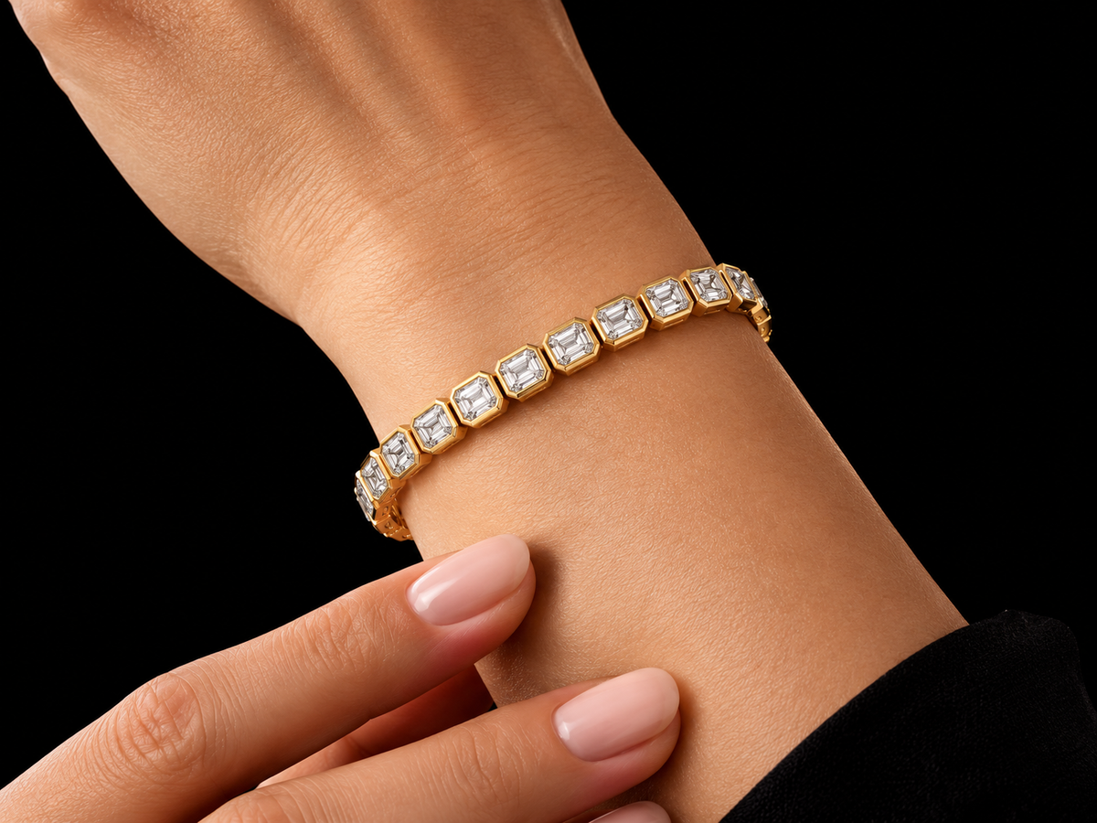 Emerald-cut bezel-set lab-grown diamond tennis bracelet worn on the wrist