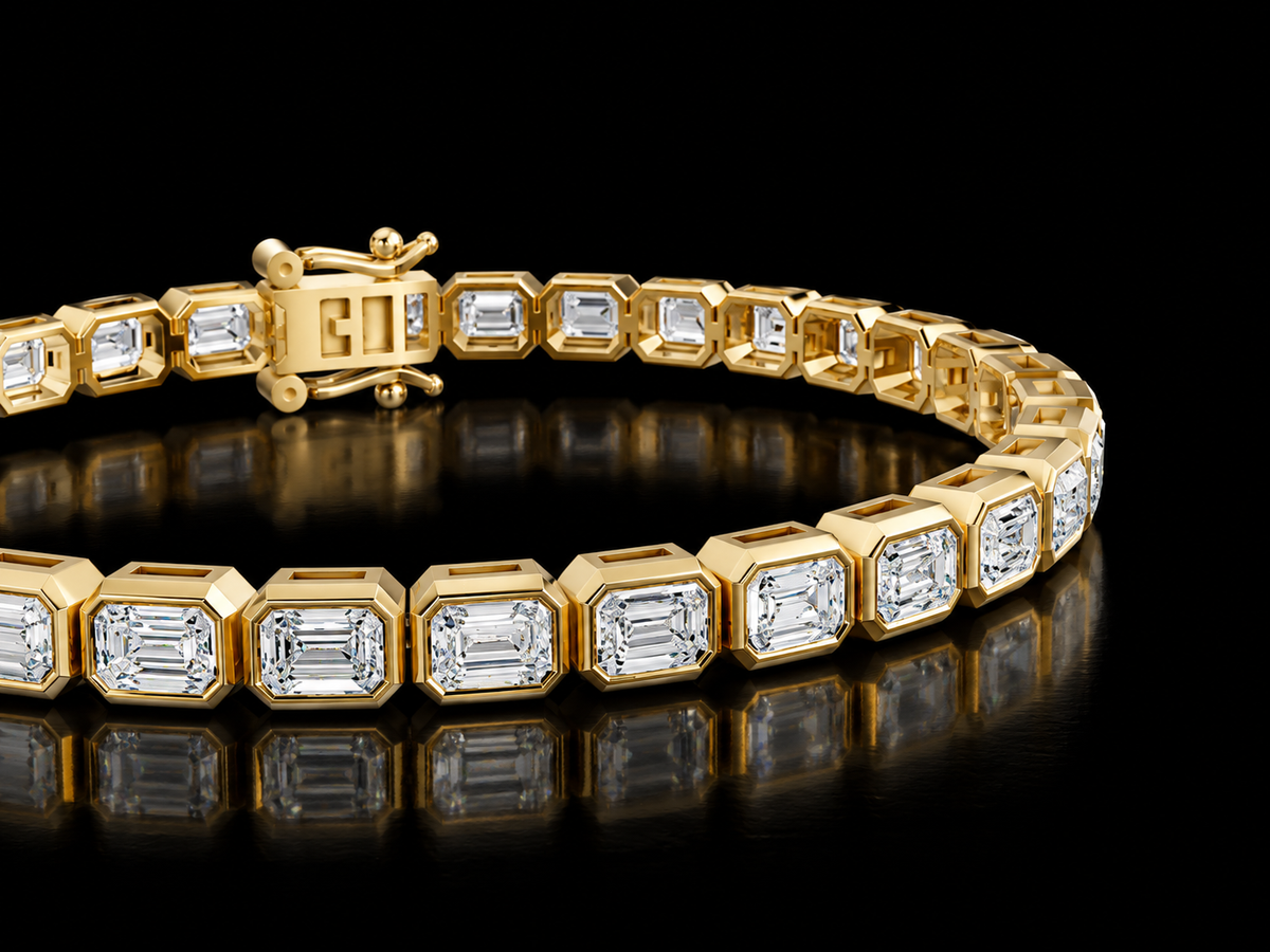 Emerald-cut bezel-set lab-grown diamond tennis bracelet in yellow gold, close view